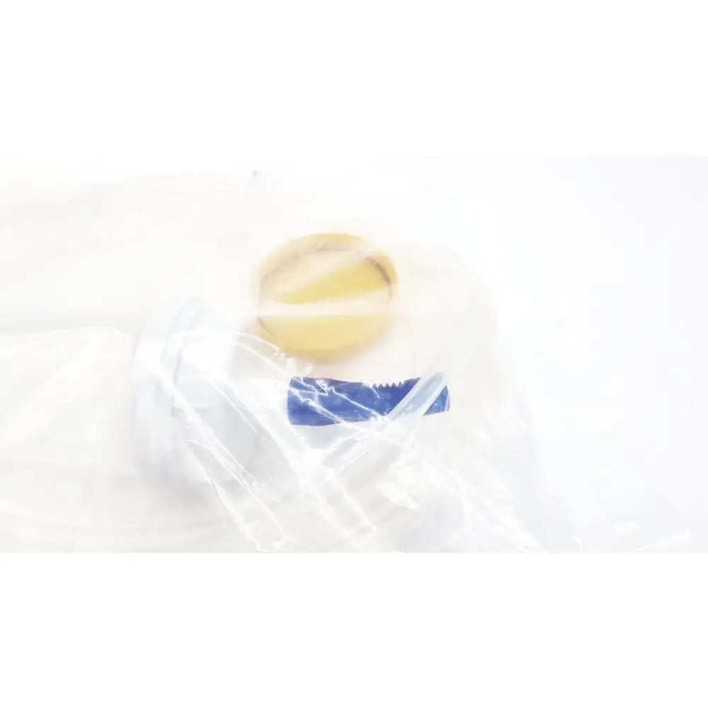 A translucent plastic bag containing a yellow circular scientific m0068402980 stone catcher for boston scientific use