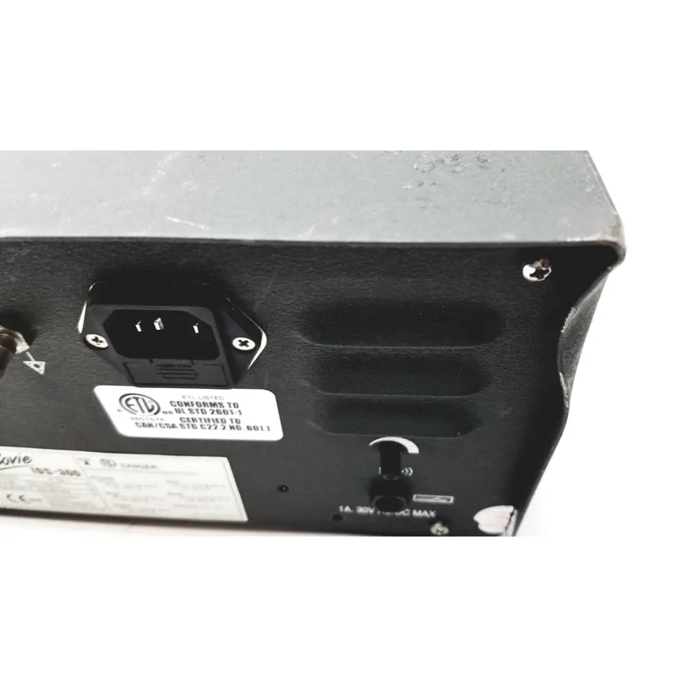 Rear panel of black plastic bovie ids-300 electrosurgical generator with three-pronged ac input and certification labels