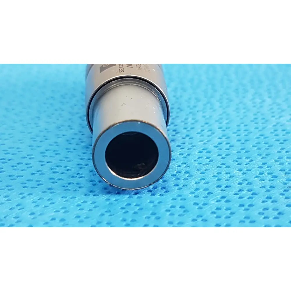 Silver metallic cylindrical brasseler n10ti led coupler with hollow interior and engraved markings for dental handpiece connection