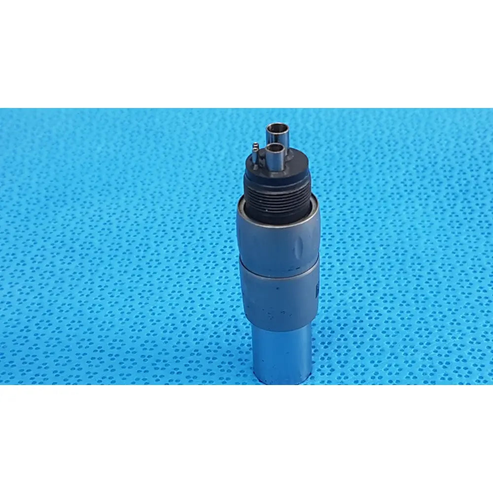 Silver-colored metallic brasseler n10ti led coupler with threaded black top and two cylindrical ports for dental use