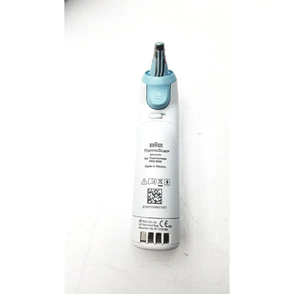 White and light blue braun thermoscan pro ear thermometer ref 901054 with charging bay and ergonomic design