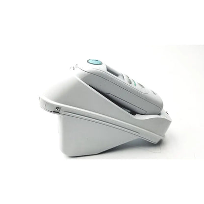 White philips sonicare electric toothbrush resting in its charging base contrasting with braun thermoscan pro ear thermometer ref