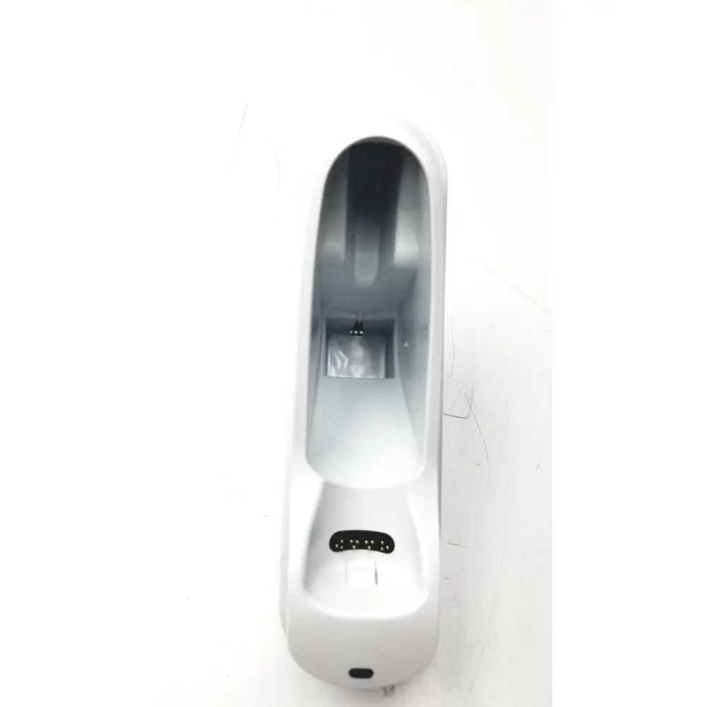 White plastic car phone mount with sleek curved design and black rubberized grips shown with braun thermoscan pro 6000 ear thermometer ref charging bay