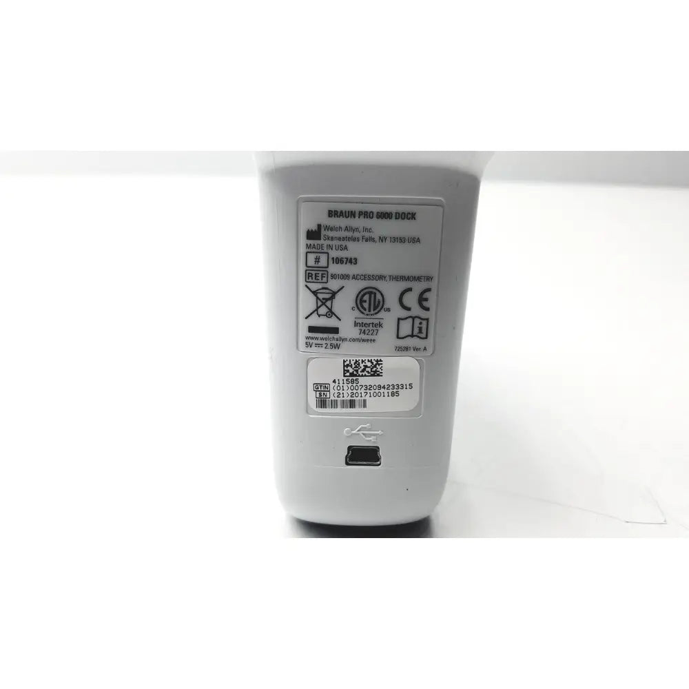White plastic braun thermoscan pro 6000 ear thermometer ref charging dock with usb port and specification label