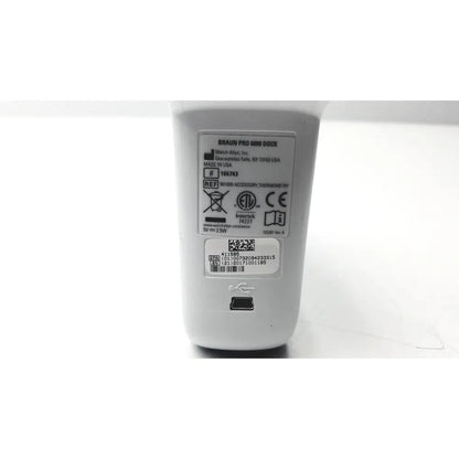 White plastic braun thermoscan pro 6000 ear thermometer ref charging dock with usb port and specification label