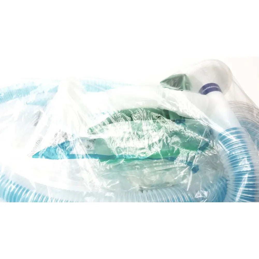 Green and white medical breathing circuit with breathing bag coaxial and blue corrugated tubing in clear plastic packaging