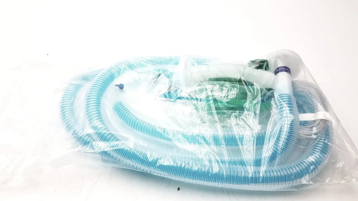 Blue corrugated plastic breathing circuit with clear face mask and white connectors in bag coaxial circuit packaging