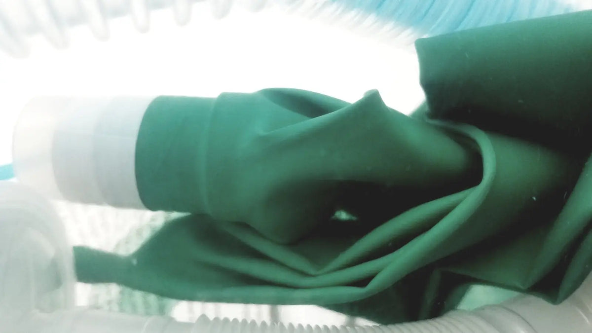 Breathing circuit with dark green flexible fabric tube and white plastic connector for bag coaxial circuit use