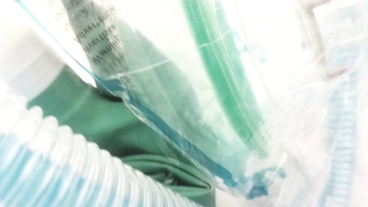 Green medical oxygen mask with clear plastic packaging in a breathing bag coaxial circuit breathing circuit product