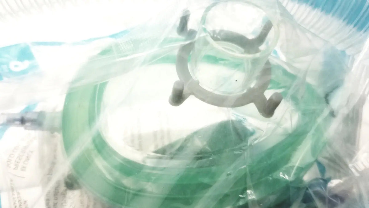 Green silicone breathing circuit face mask with clear plastic frame and gray adjustable straps for bag coaxial circuit
