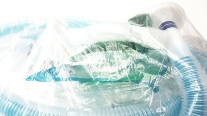 Green and white medical breathing circuit with breathing bag coaxial and blue corrugated tubing in clear plastic packaging