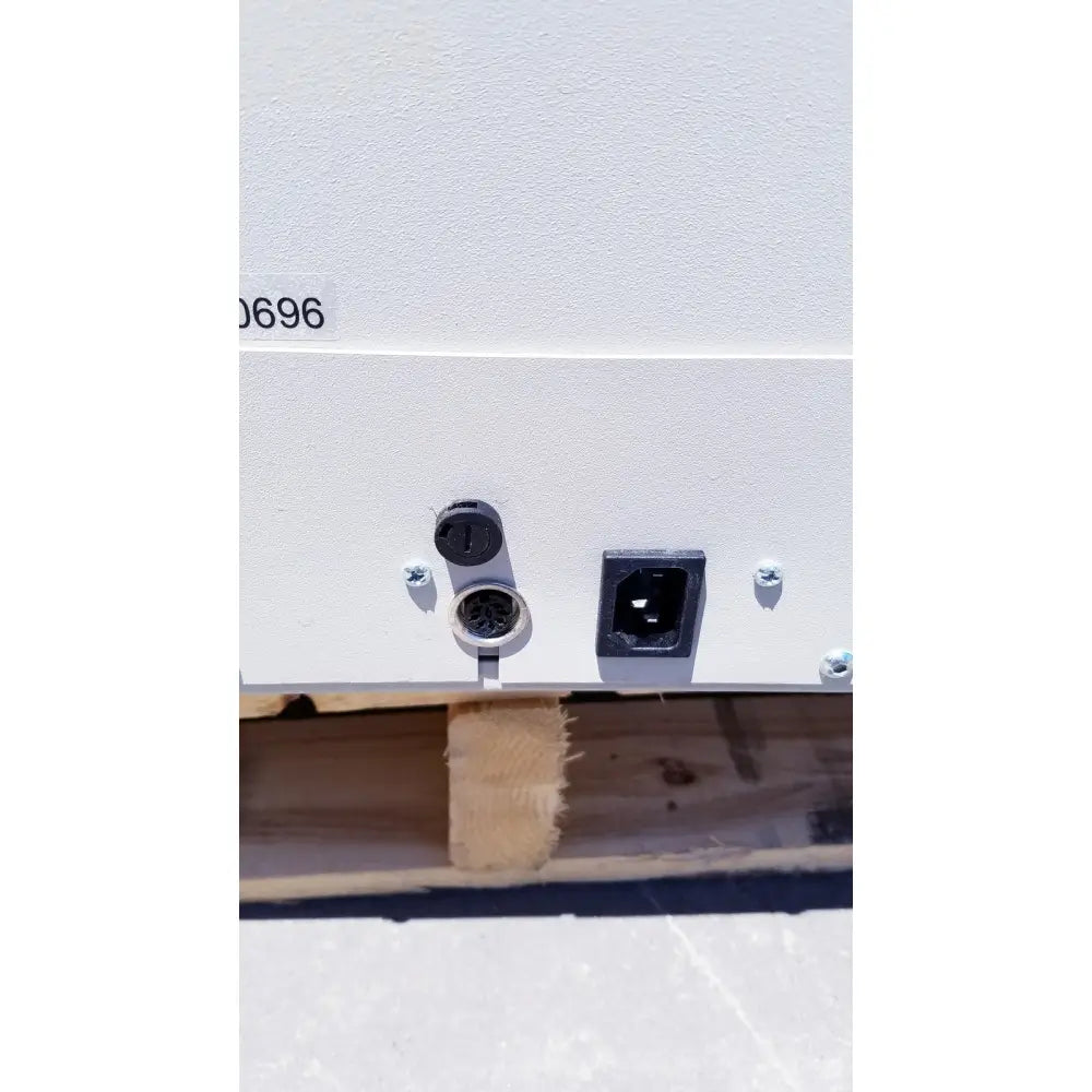 White industrial power supply unit with black ports on the back of brewer access high-low exam table