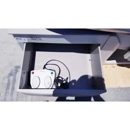 White plastic brewer access high-low controller for brewer access exam table with red blue buttons and coiled black cord