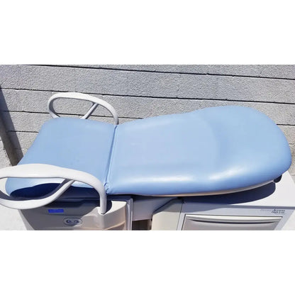 Brewer Access high-low exam table with light blue padded surface white metal frame and curved armrests