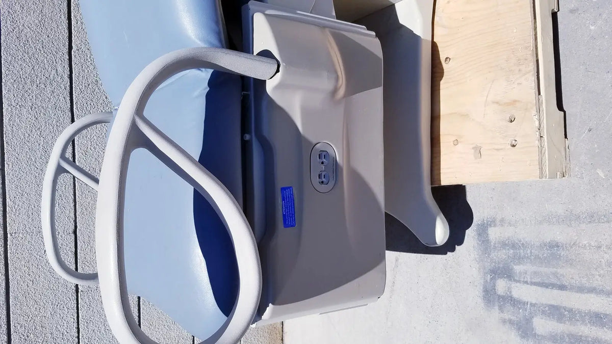 Gray plastic brewer access high-low exam table seat with blue cushion and white handlebars for medical use