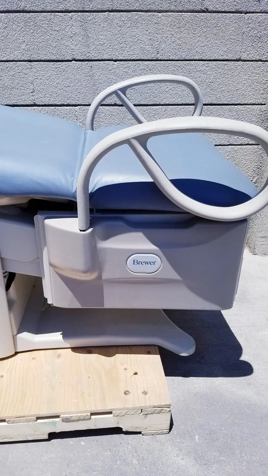 Gray and blue brewer access high-low exam table with white metal frame branded brewer access for medical use