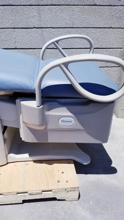 Gray and blue brewer access high-low exam table with white metal frame branded brewer access for medical use