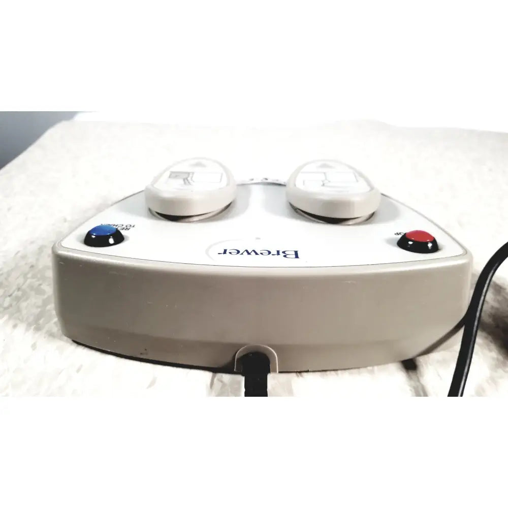 Beige plastic brewer high low power exam foot pedal with two white oval knobs and blue on and red off buttons