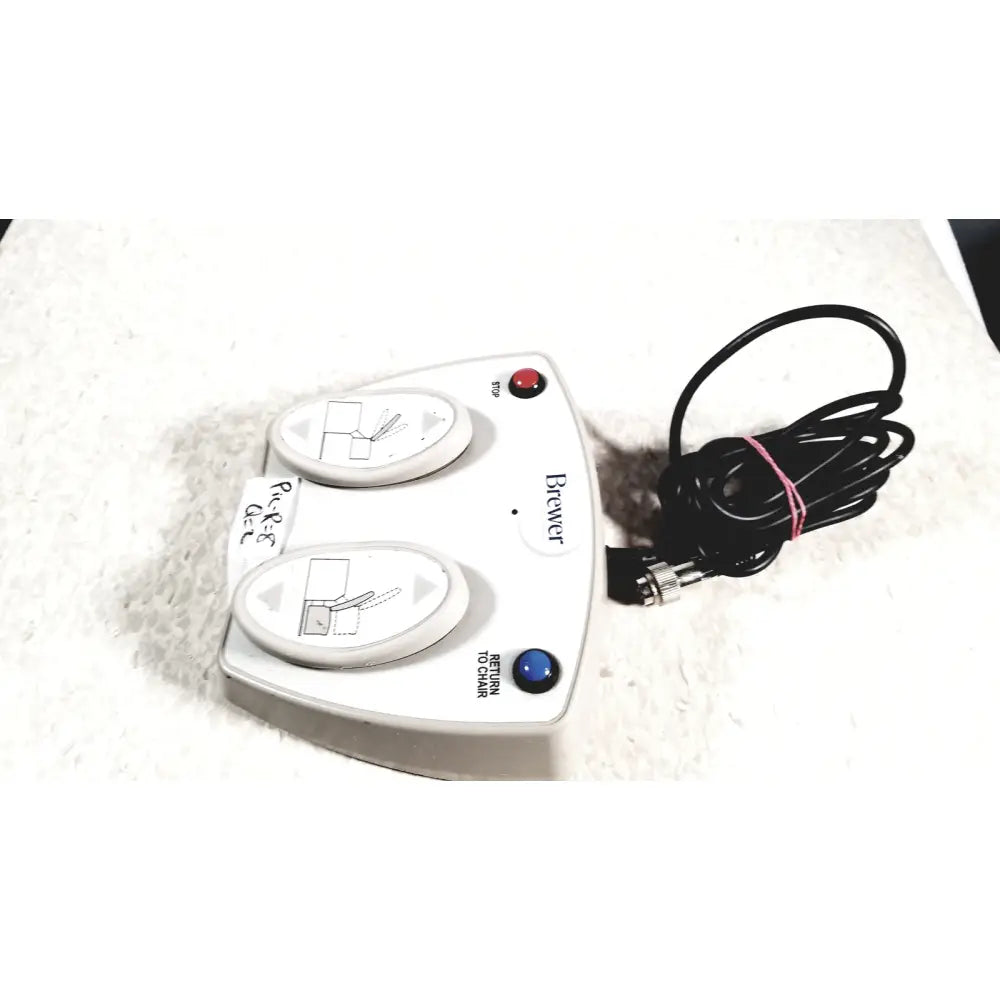White plastic brewer high low power exam foot pedal with two oval control pads and coiled black power cord