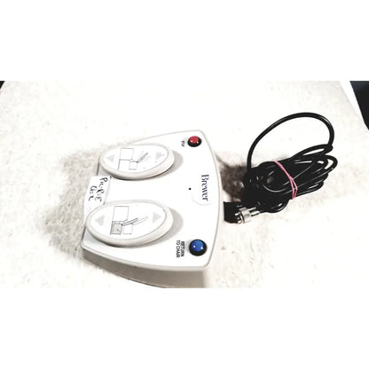 White plastic brewer high low power exam foot pedal with two oval control pads and coiled black power cord