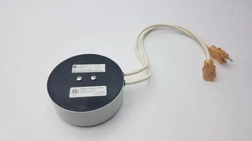 Gray cylindrical bridegeport magnetics tortran ip600 power transformer with black top and beige cord with orange plugs