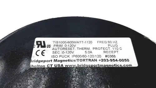 Black cylindrical electrical transformer with white label showing technical specs for bridgeport magnetics tis1000-600watt-1120