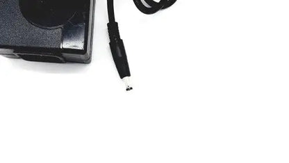 Black plastic laptop charger with coiled power cord and cylindrical connector for bridgepower corp bpm050s12f02 medical power supply