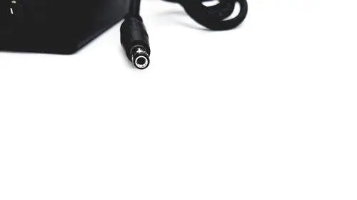Black power adapter with coiled cable and cylindrical connector for bridgepower corp bpm050s12f02 medical power supply