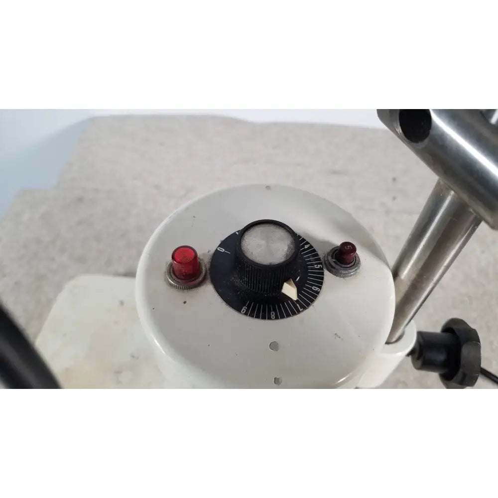 White circular dial with black numbered scale and central knob flanked by red push buttons on brinkmann kinematica homogenizer mixer