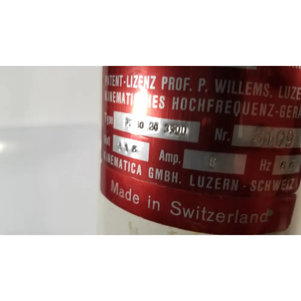 Red cylindrical brinkmann kinematica homogenizer mixer with silver metallic label made in switzerland showing technical specs
