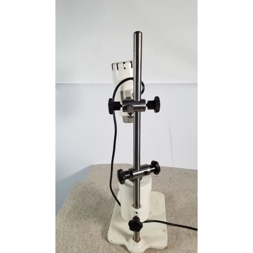 White laboratory stirrer with metallic rod and black knobs used in brinkmann kinematica homogenizer mixer device