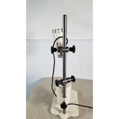 White laboratory stirrer with metallic rod and black knobs used in brinkmann kinematica homogenizer mixer device