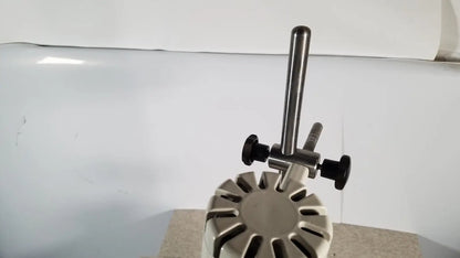 Silver metallic brinkmann kinematica homogenizer mixer with black adjustment knobs and circular base with radial slots