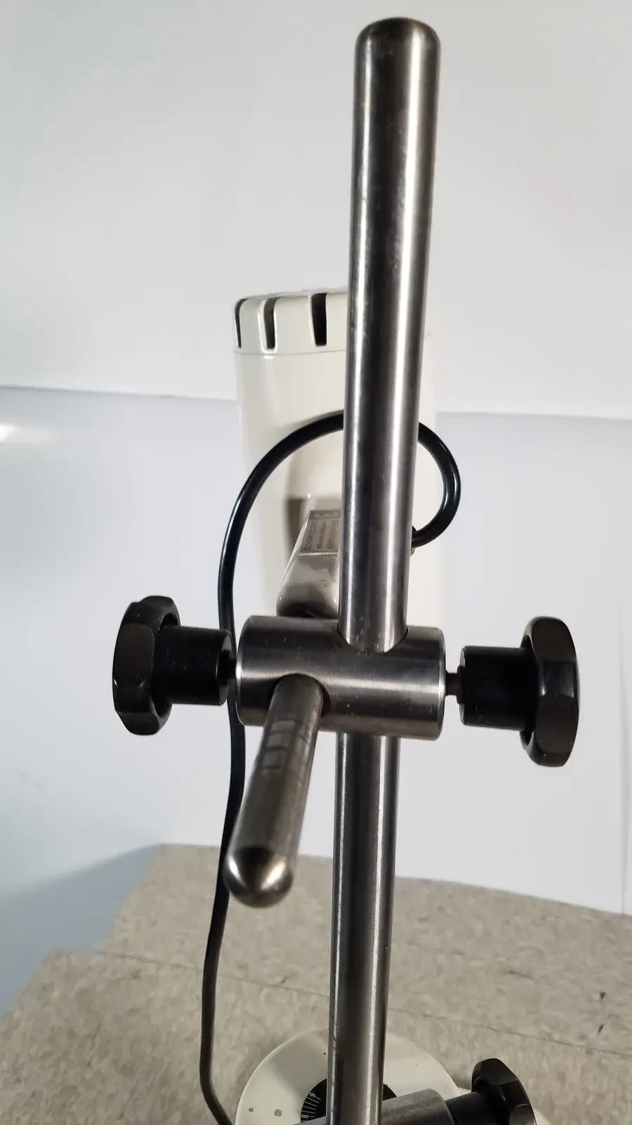 Stainless steel microscope stand with black adjustment knobs and central handle for brinkmann kinematica homogenizer mixer