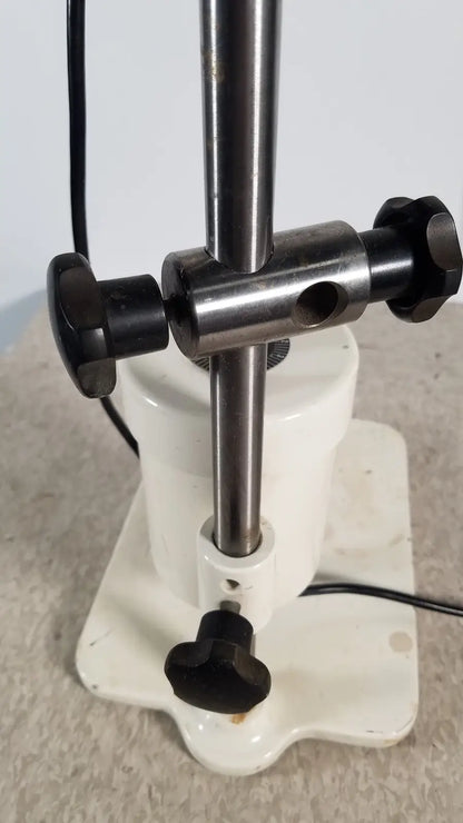 White ceramic base with black knobs and metallic rod of brinkmann kinematica homogenizer mixer for lab use