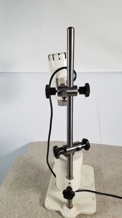 White laboratory stirrer with metallic rod and black knobs used in brinkmann kinematica homogenizer mixer device