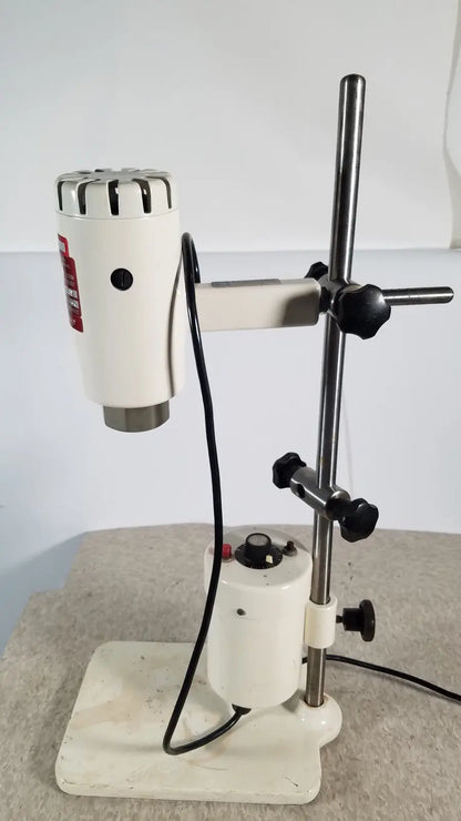 White brinkmann kinematica homogenizer mixer with metallic top and black knobs mounted on adjustable stand