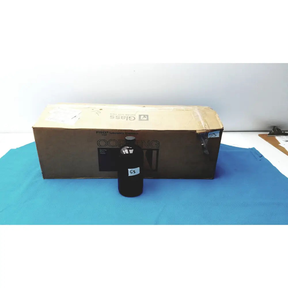 Black glass chemical bottle with silver cap and white label for reagent storage lab use