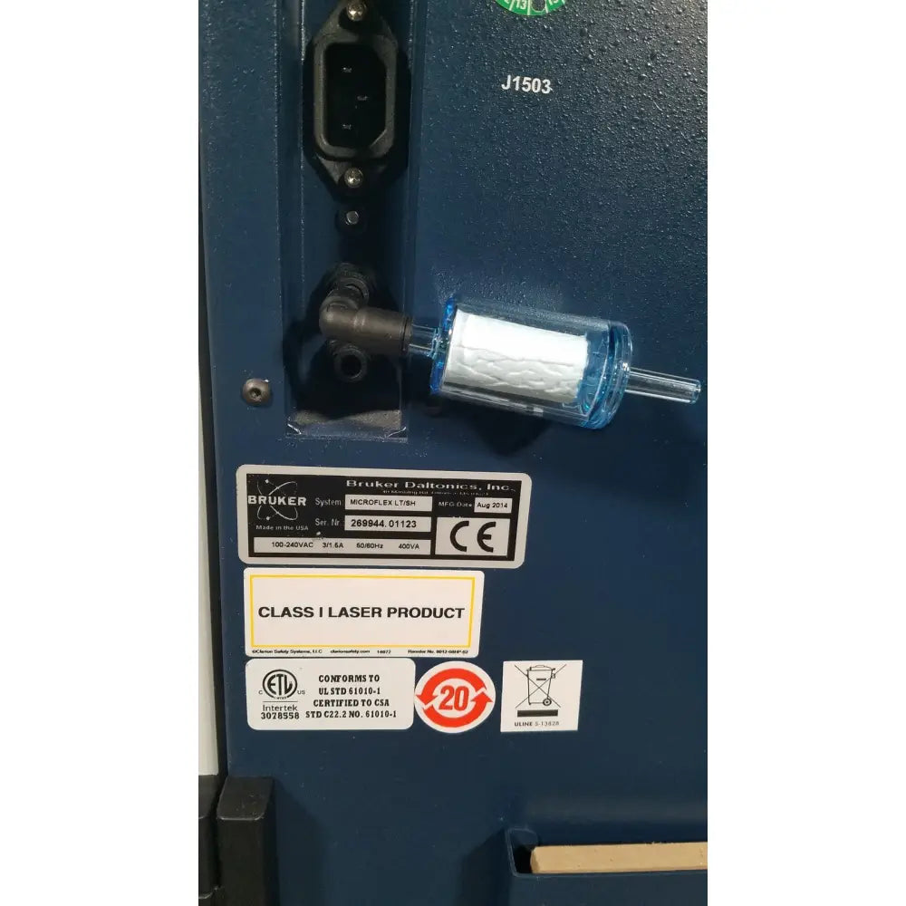 Blue cylindrical filter with white pleated element on dark blue bruker microflex lt sh mass spectrometer for reuse medical applications