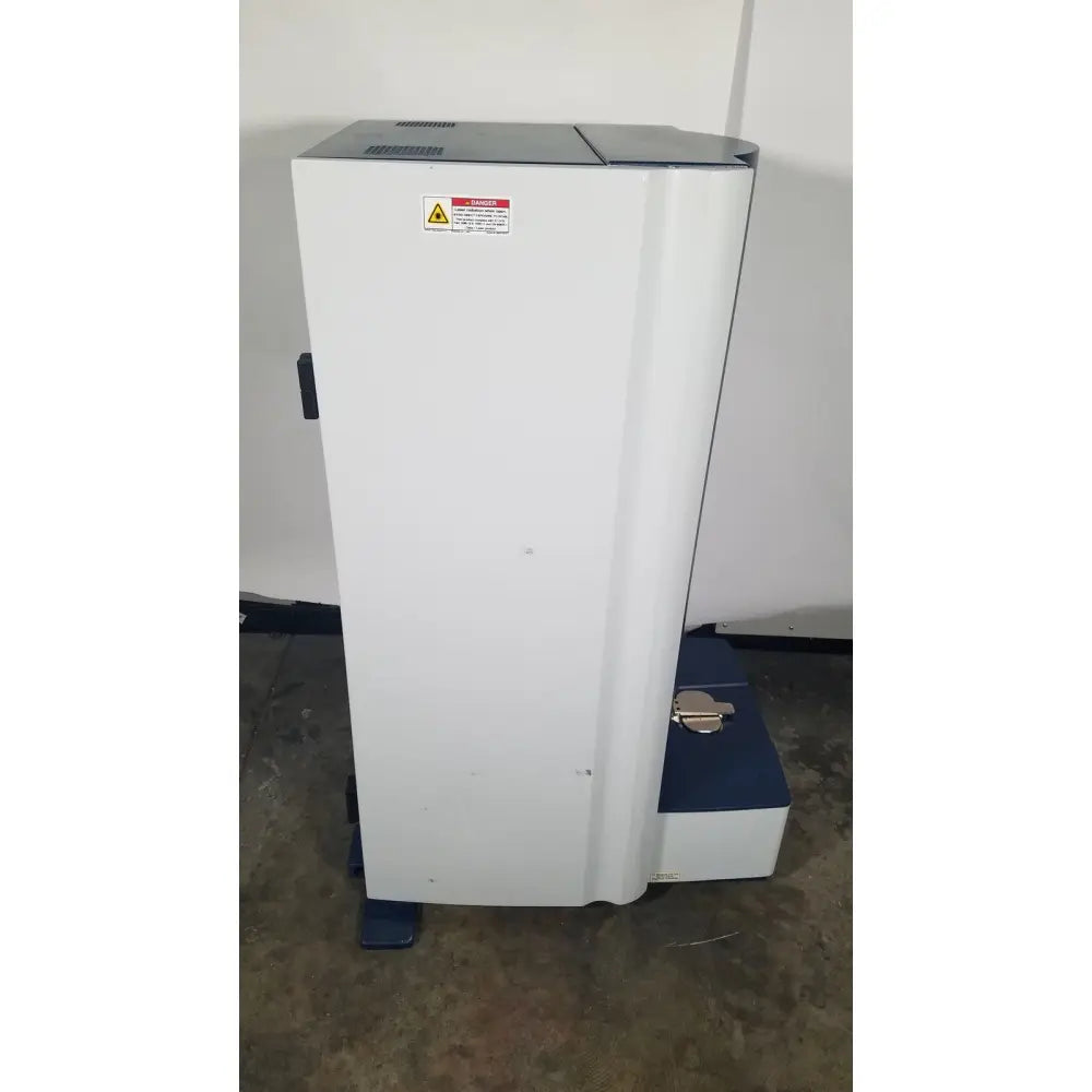 White and blue bruker microflex lt/sh mass spectrometer with warning label for reuse medical and laboratory analysis