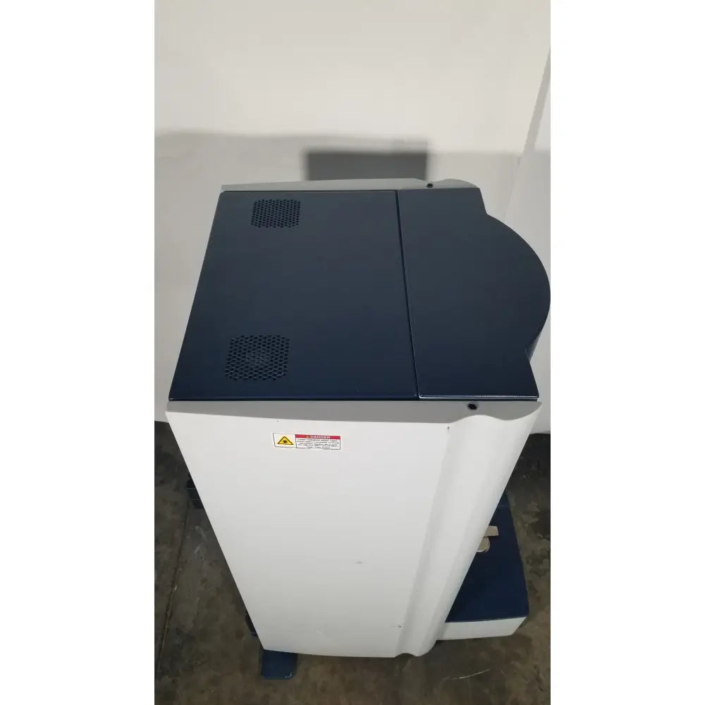 Bruker Microflex mass spectrometer featuring a white and navy blue multifunction printer for medical reuse applications
