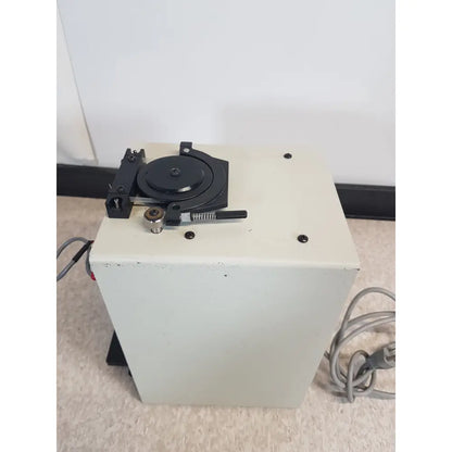 Beige rectangular buchler instruments auto density gradient fractionator with black turntable mechanism on top