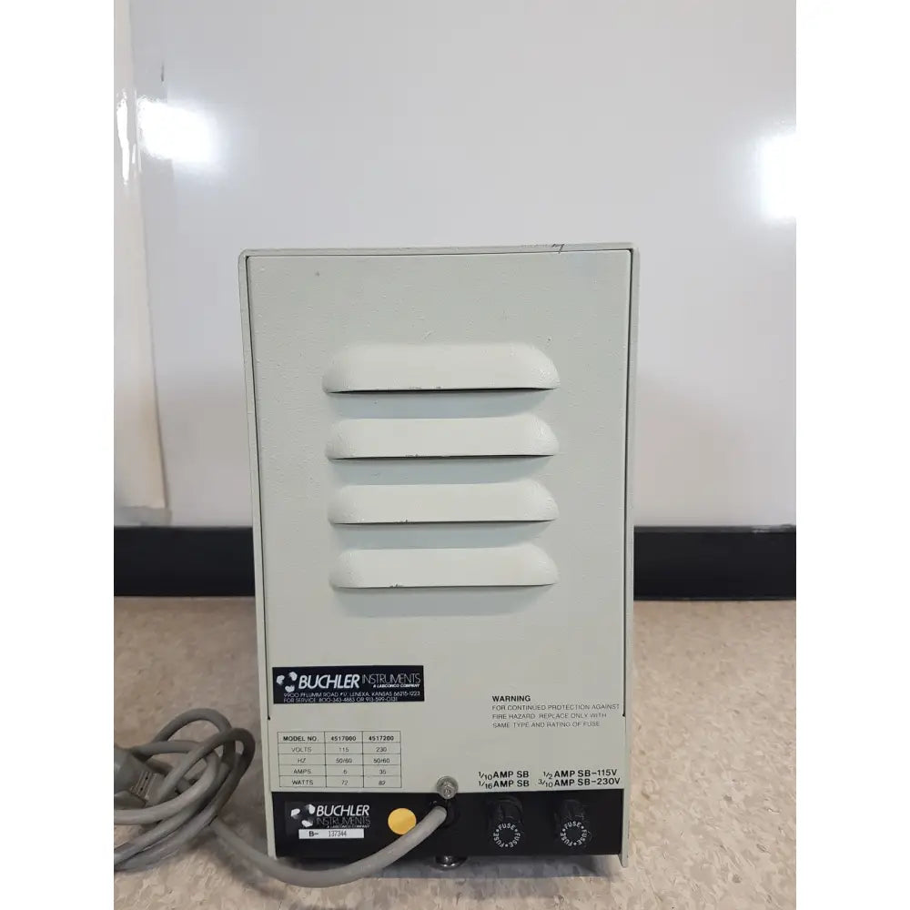 Gray metal buchler instruments auto power supply unit with horizontal ventilation slats and labeled control knobs