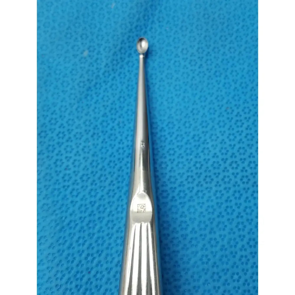 Stainless steel buggles spratt bone curette with a slender polished shaft and rounded tip for orthopedic use