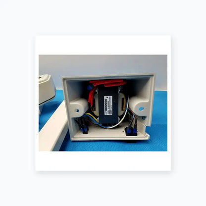 White plastic electrical enclosure housing a black transformer with red and blue wires for burton medical equipment