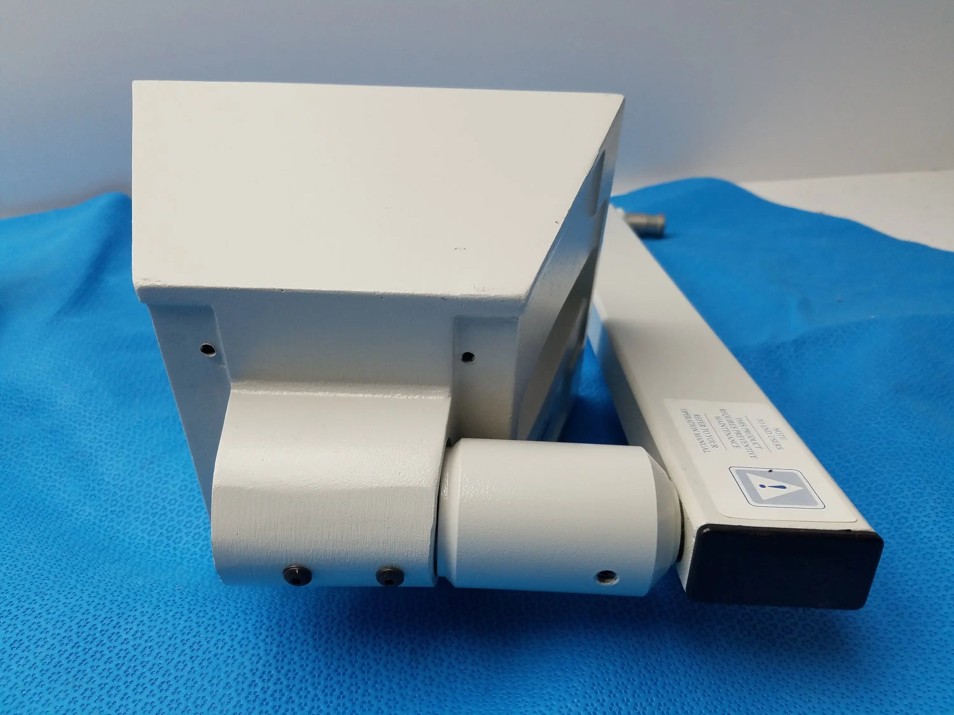 White plastic housing with internal wiring and open side panel of burton medical outpatient ii coolspot ii examination light medical equipment