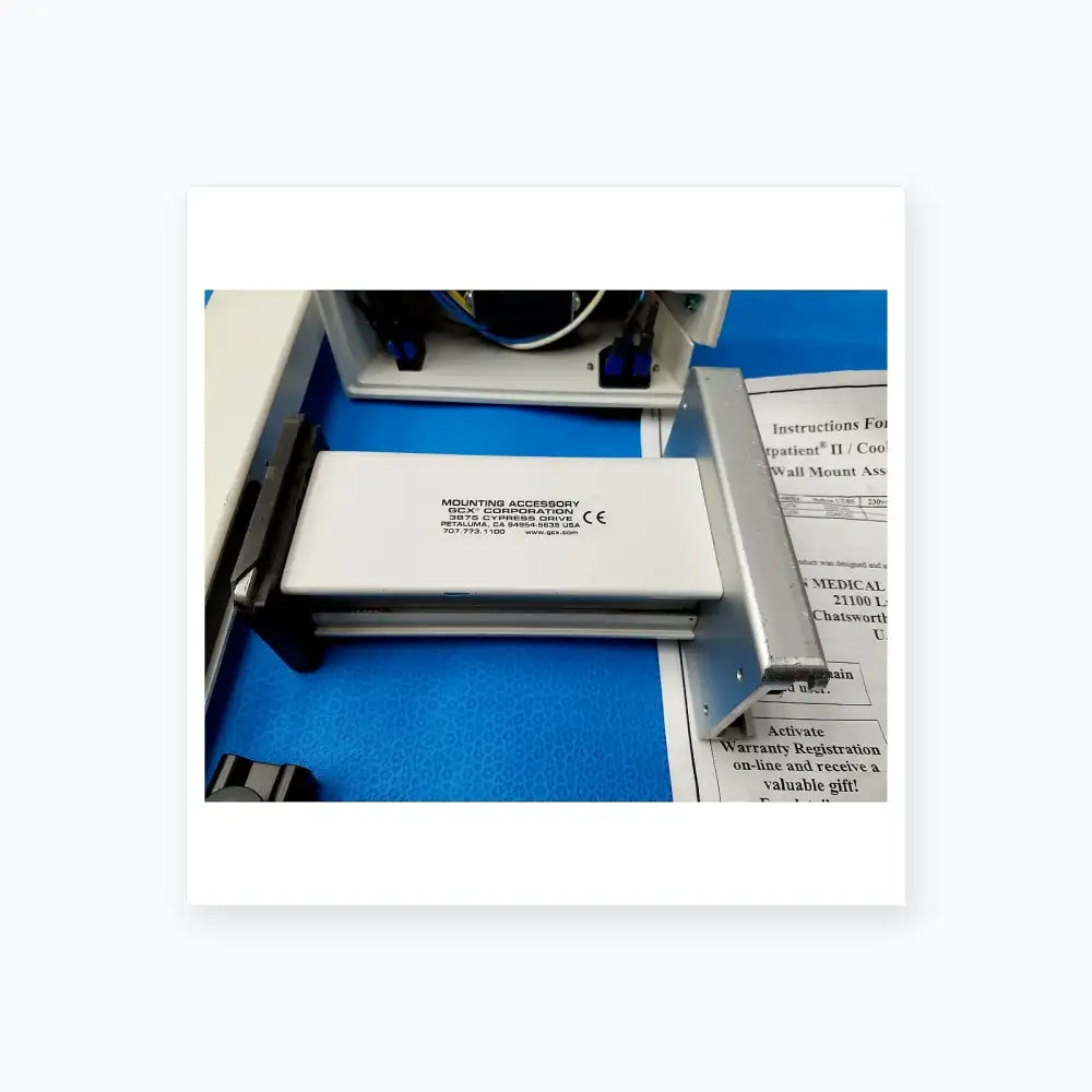White rectangular mounting accessory with black text and CE mark by gcx corporation for burton medical examination light wall mount assembly