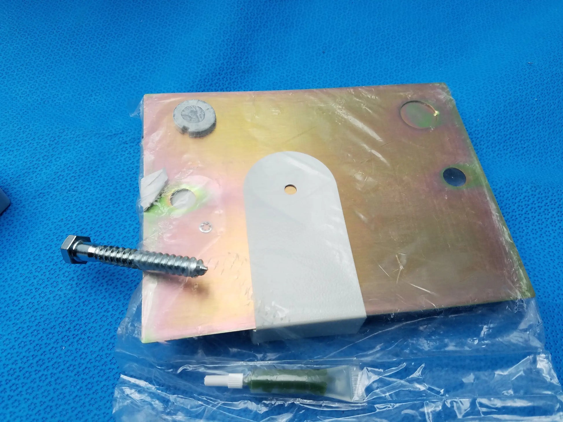Metallic bracket with white plastic insert and screw in clear plastic for burton medical outpatient ii wall mount assembly reusable medical equipment