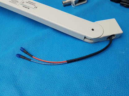 White plastic optomatic ii light rod arm with black and red wires for burton medical outpatient ii examination light wall mount assembly