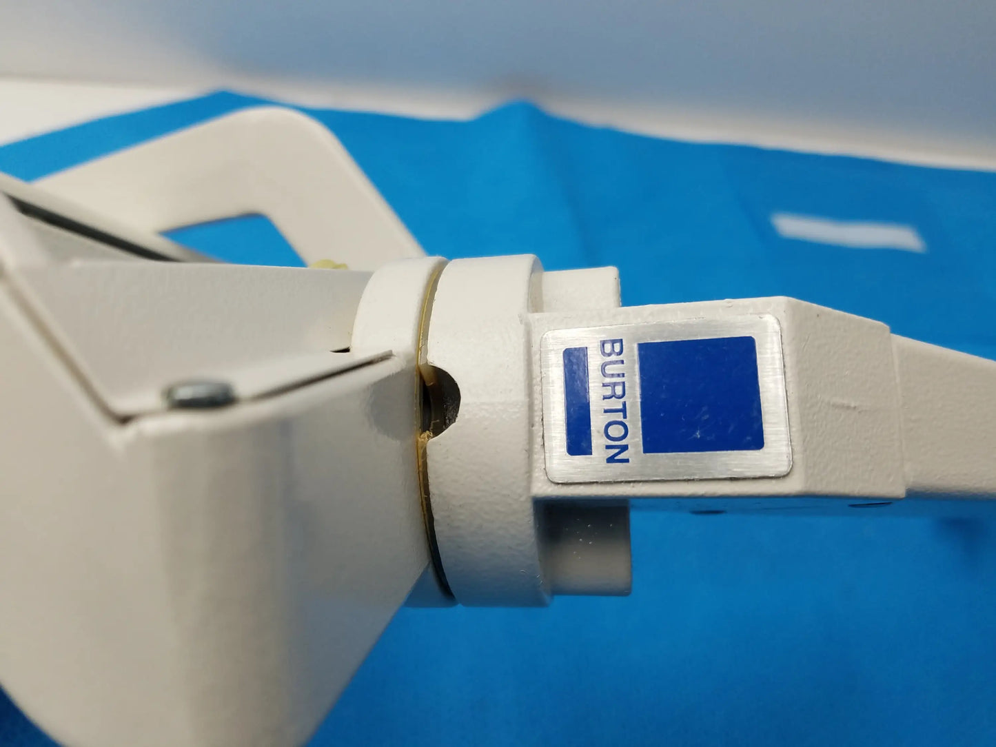 White plastic burton brand laser hair removal device with blue label and metallic accent for reuse medical equipment